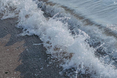 High angle view of waves splashing in sea