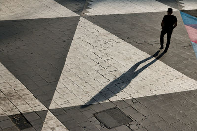 High angle view of man walking on road