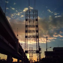 Low angle view of built structure against sky at sunset