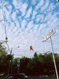 Low angle view of road sign against sky