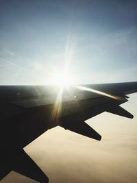 Close-up of airplane wing against sky