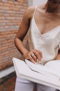 Black woman reading and writing notes in a notebook