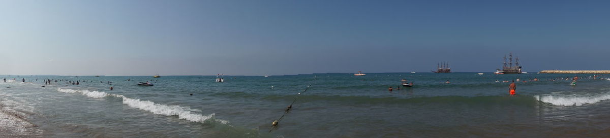 People on beach against sky