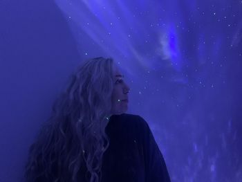 Portrait of woman looking at stars