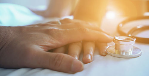 Close-up of hand holding coffee cup