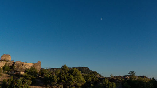 Low angle view of buildings against clear blue sky