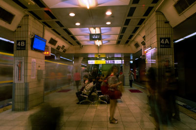 People in illuminated underground at night