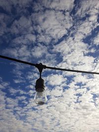 Low angle view of light bulb against sky