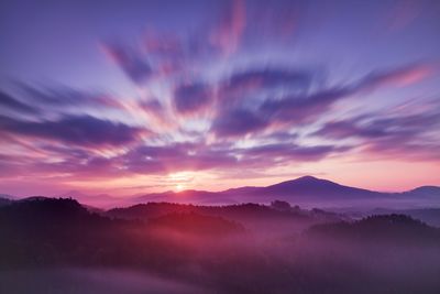 Scenic view of silhouette mountains against sky during sunset