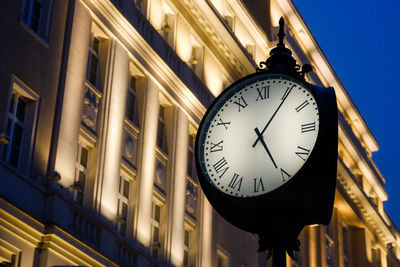 Low angle view of clock on wall