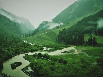 Scenic view of landscape and mountains against sky