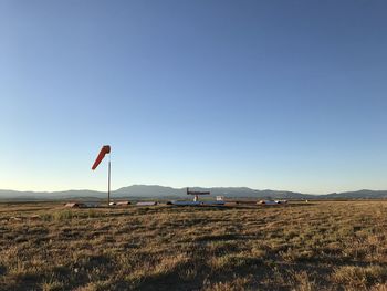 Scenic view of field against clear blue sky