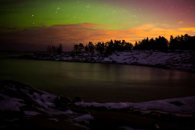 Scenic view of lake against sky at sunset