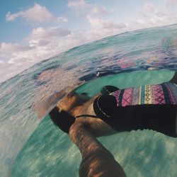 Midsection of man on beach against sky
