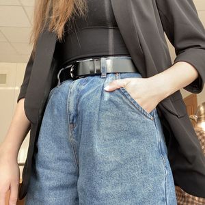 Midsection of woman standing with hand in pocket