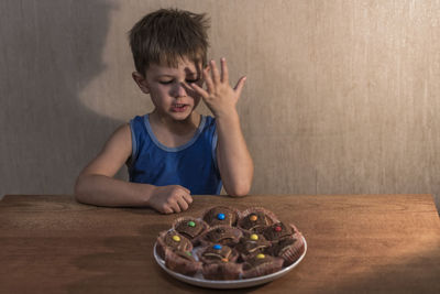 Portrait of boy on table