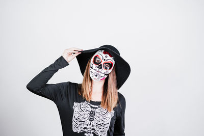 Portrait of woman standing against white background