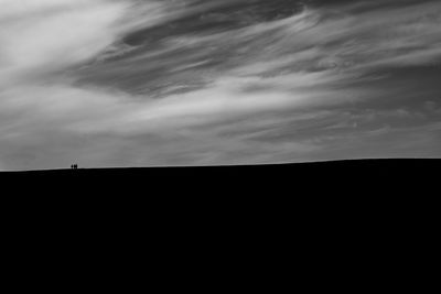 Low angle view of silhouette landscape against sky