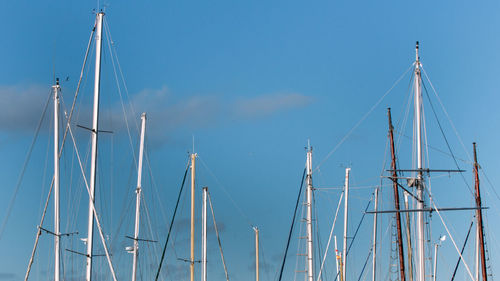 Low angle view of sailboat against blue sky