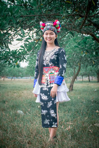 Portrait of woman standing on field