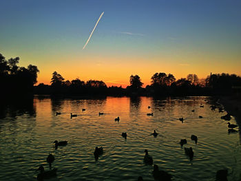 Scenic view of calm lake at sunset