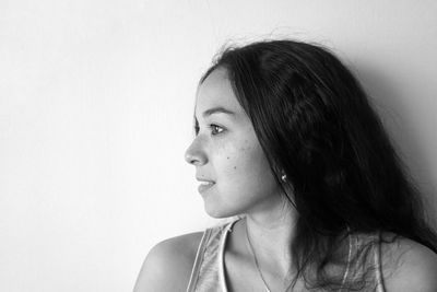 Close-up portrait of young woman against white background