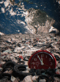 High angle view of clock on rock
