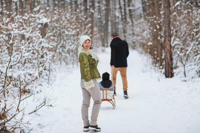 Rear view of people walking in snow