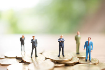 Figurines standing on coins