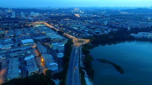 High angle view of illuminated cityscape against sky