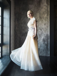 Beautiful bride standing by window