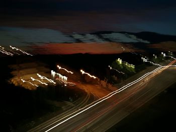 High angle view of light trails on road at night