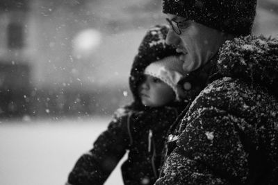 Father carrying baby daughter during winter