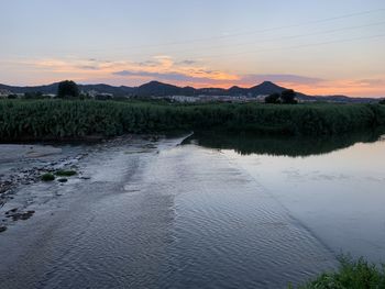 Scenic view of land against sky during sunset