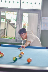 Man playing with ball at table