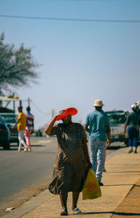 Rear view of people walking on street