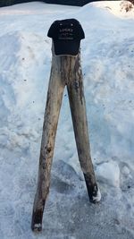 Low section of person standing on snow covered land