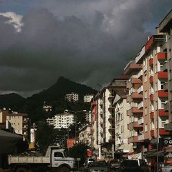 Buildings against cloudy sky