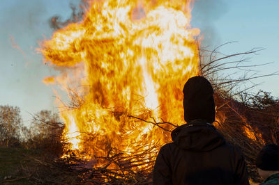 Rear view of man standing against bonfire