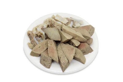 High angle view of chopped slices in bowl against white background