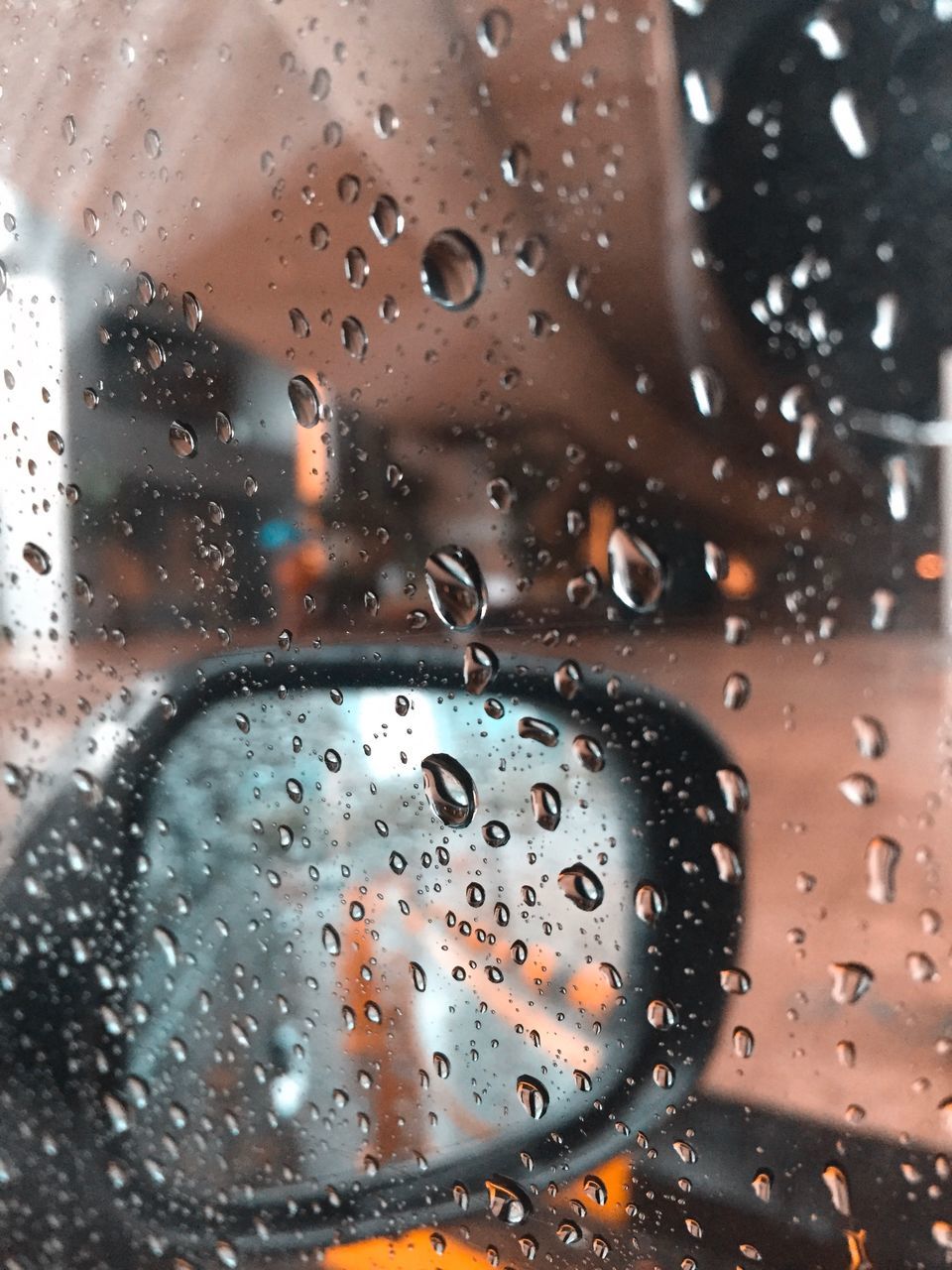 WATER DROPS ON GLASS WINDOW OF CAR