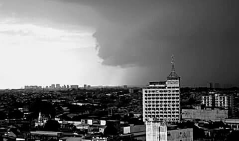 Buildings against cloudy sky