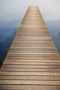 Surface level of wooden pier against sky