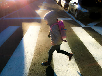 High angle view of girl walking on sunny day