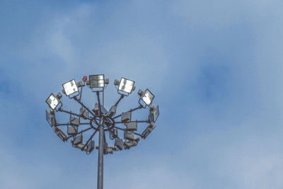 Low angle view of floodlight against blue sky