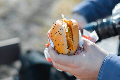 Close-up of hand holding donut