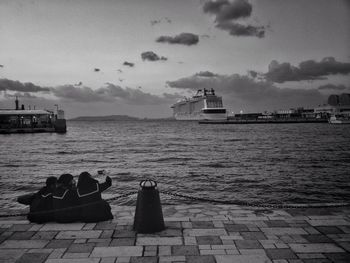 Boat moored on sea against sky