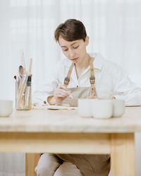 Female dentist working at table