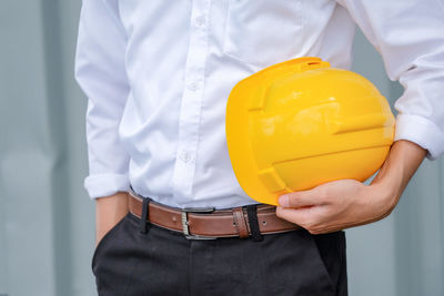 Midsection of man working with umbrella