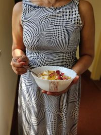 Midsection of woman holding ice cream